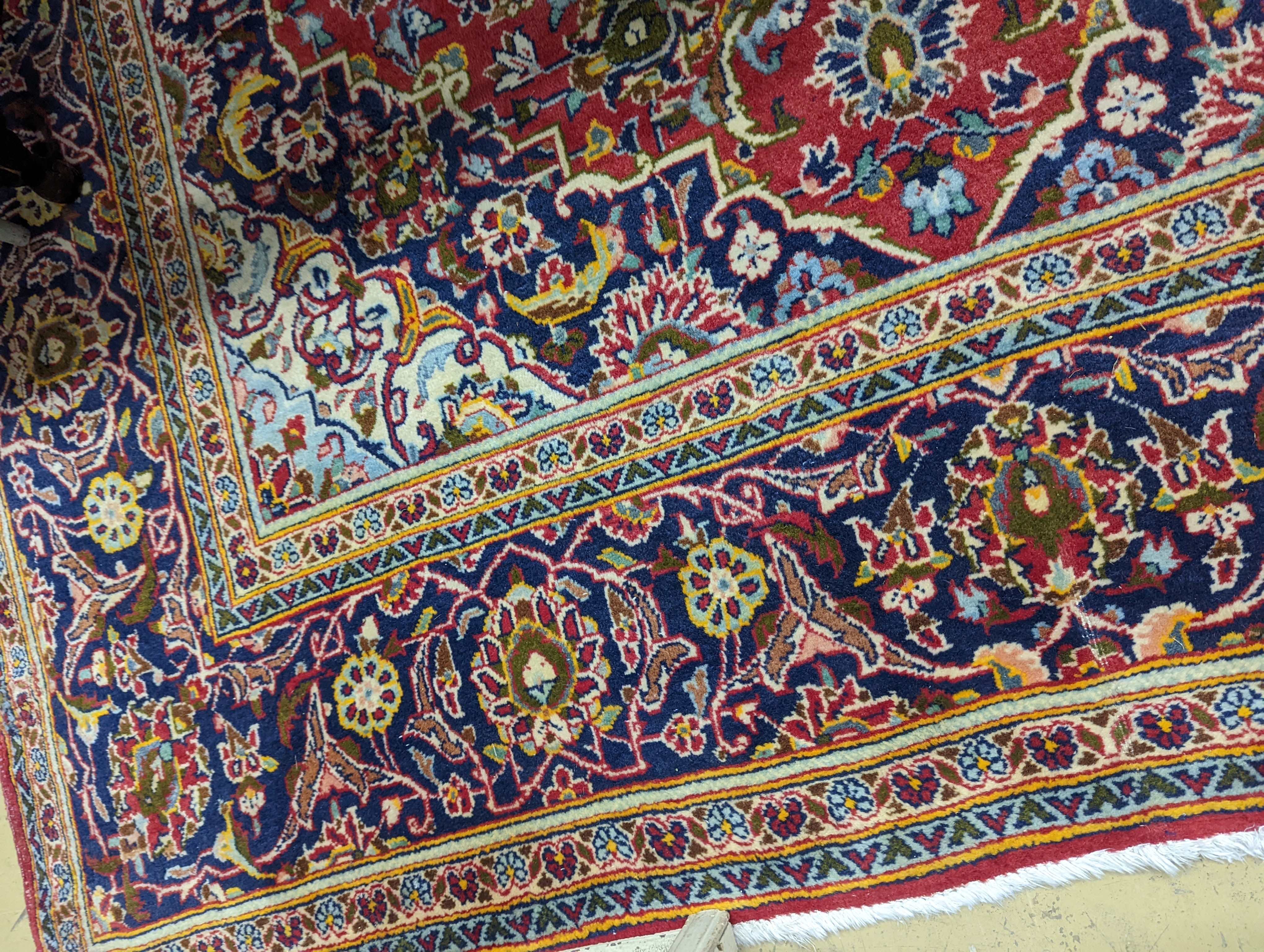 A Heriz red ground carpet, 320 x 204cm